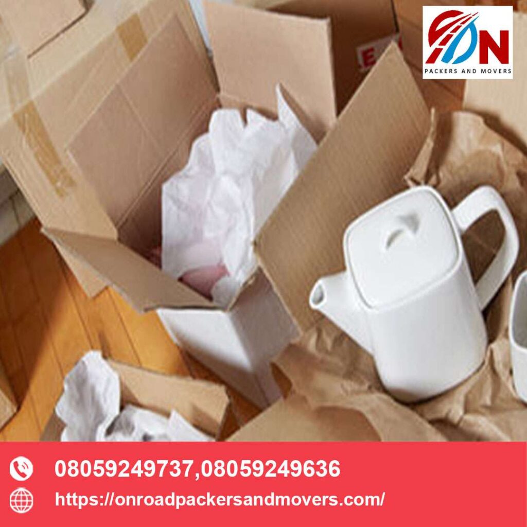 grouping delicated items in one single carboard for packers and movers from bangalore service